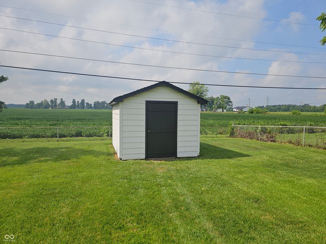 view of shed featuring a fenced backyard, a rural view, and agricultural area | Image 7