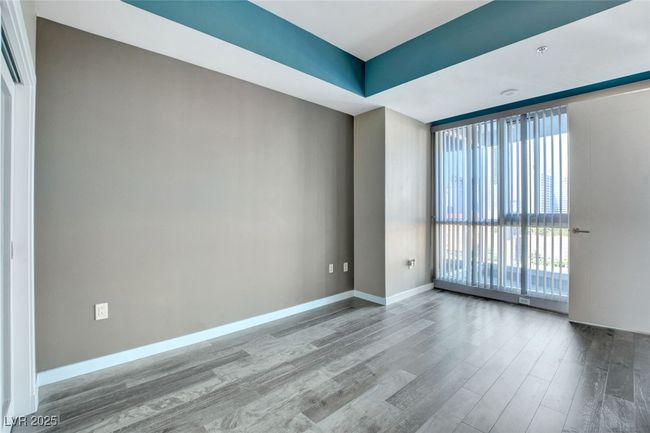 Primary bedroom featuring expansive windows, wood finished floors, and baseboards | Image 19