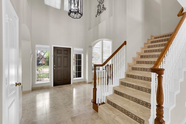 Entryway with a high ceiling, a wealth of natural light, and stairs | Image 6