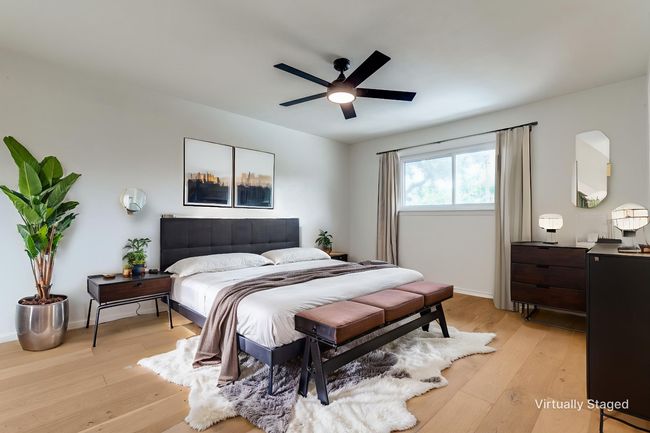 Bedroom with light wood finished floors and a ceiling fan | Image 17