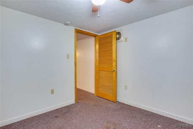 2nd unit Carpeted empty room featuring a textured ceiling and ceiling fan | Image 37