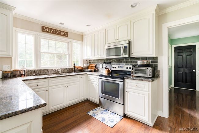 The kitchen leads into an awesome mud/laundry room | Image 13