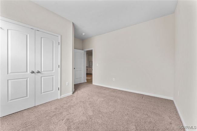 Unfurnished bedroom featuring carpet flooring, baseboards, and a closet | Image 39