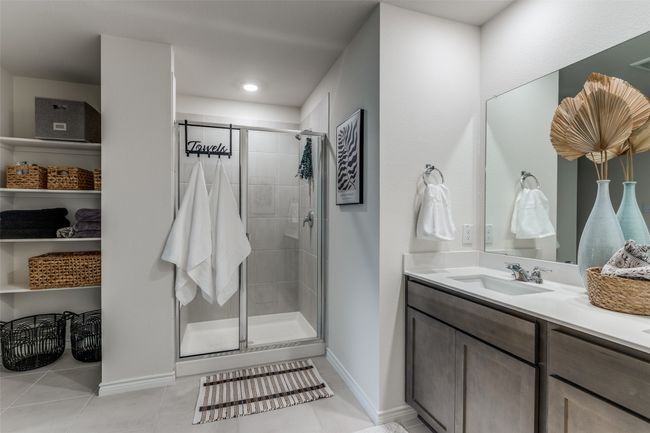 Primary Bathroom View open shelving storage for towels and toiletries. | Image 15