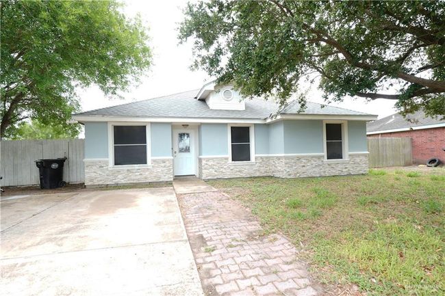 View of front of property featuring stone siding, stucco siding, and roof with shingles | Image 19