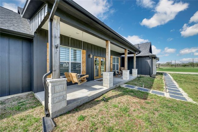 View of exterior entry featuring a patio and a yard | Image 6