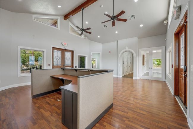 Kitchen with high vaulted ceiling, a wealth of natural light, french doors, and beamed ceiling | Image 7