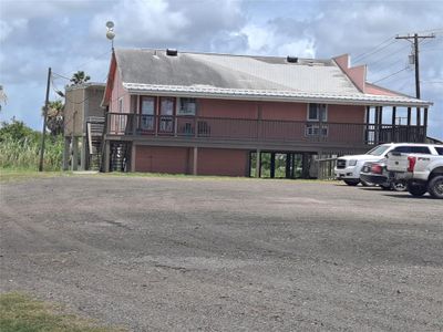 SIDE VIEW. WHEELCHAIR ACCESS RAMP IS ON FRONT CORNER. TWO SETS OF STAIRS. COVERED PORCH AROUND BUILDING. | Image 3