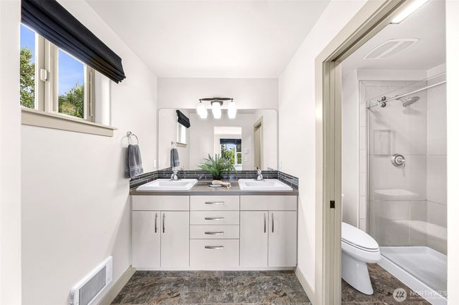 Double vanity, tiled spacious shower with glass door. | Image 22