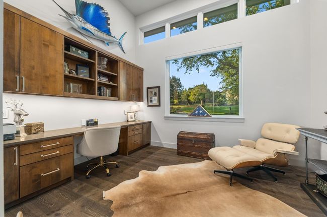 Office space with built in desk, a high ceiling, baseboards, and dark wood-style floors | Image 18
