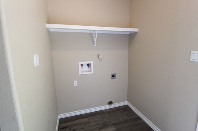 Laundry area with electric dryer hookup, washer hookup, and dark wood-style flooring | Image 18