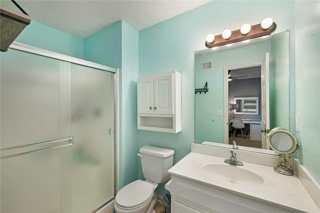 Full bath with a stall shower, toilet, vanity, and a textured ceiling | Image 26