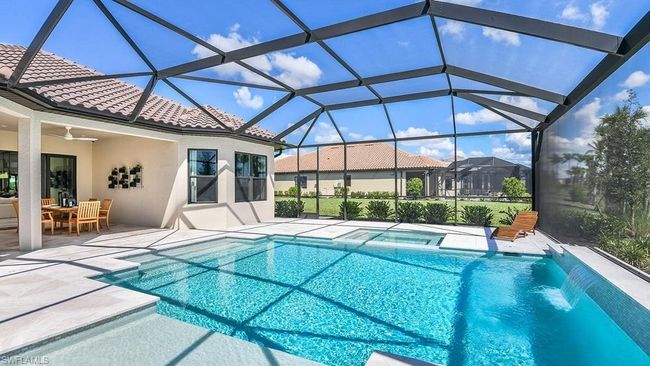 View of swimming pool featuring a patio, outdoor dining area, ceiling fan, and a pool with connected hot tub | Image 18