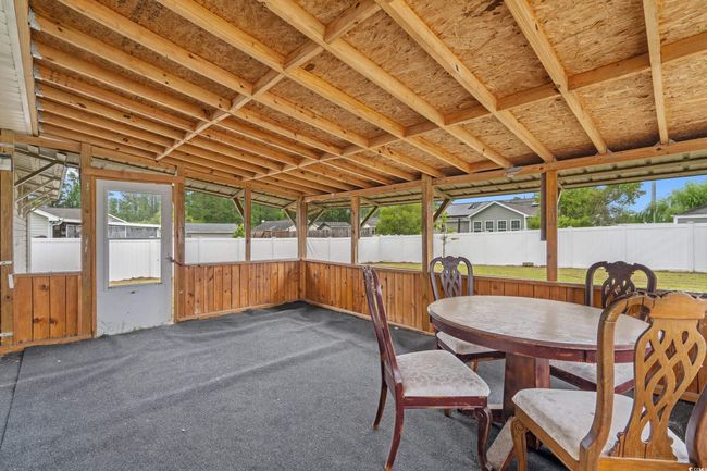 Sunroom featuring outdoor dining area | Image 24