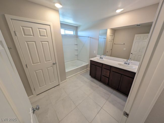 Bathroom featuring double vanity, shower / bath combination, and tile patterned flooring | Image 22