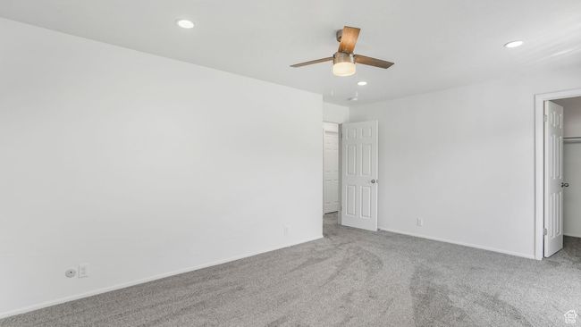 Unfurnished downstairs bedroom with recessed lighting, carpet flooring, baseboards, and a spacious closet | Image 14