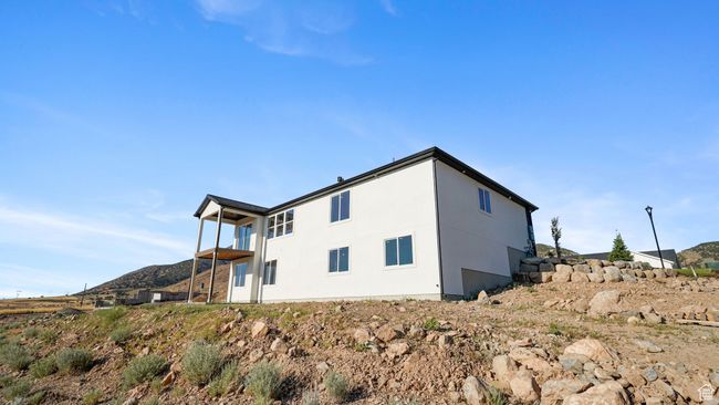 View of side of property featuring a mountain view and stucco siding | Image 29