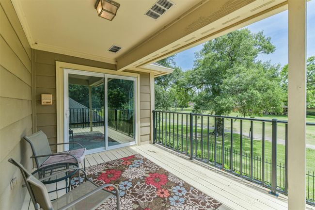 Covered Balcony off the Game Room offers splendid views of the green! Sooo many choices of fun places to hang out in this home! | Image 34