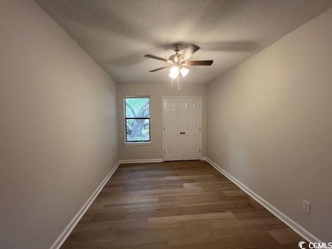 Entryway featuring a textured ceiling, ceiling fan, dark wood finished floors, and baseboards | Image 23