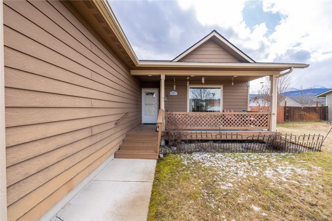 Doorway to property featuring covered porch and fence | Image 31