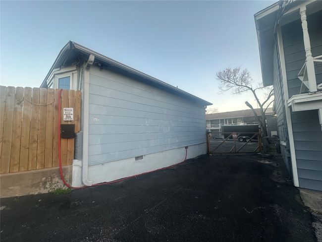 View of property exterior featuring fence | Image 11