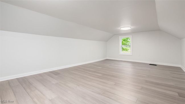 Bedroom 3 featuring lofted ceiling and light wood-style flooring | Image 12