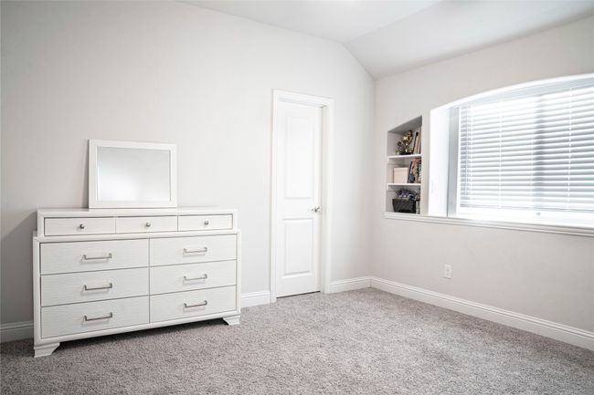 Unfurnished bedroom with lofted ceiling, baseboards, and carpet floors | Image 11