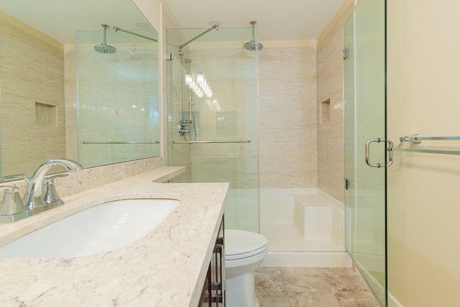 Full bathroom with a shower stall, vanity, and toilet | Image 23
