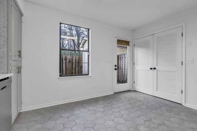 Laundry located behind closet doors in kitchen. | Image 11