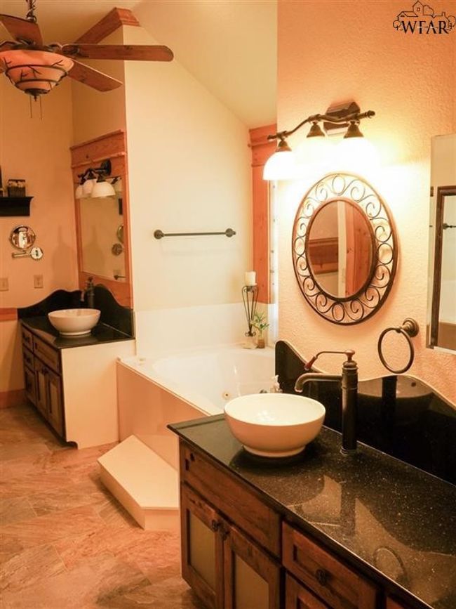 Bathroom featuring a washtub, vanity, and ceiling fan | Image 6