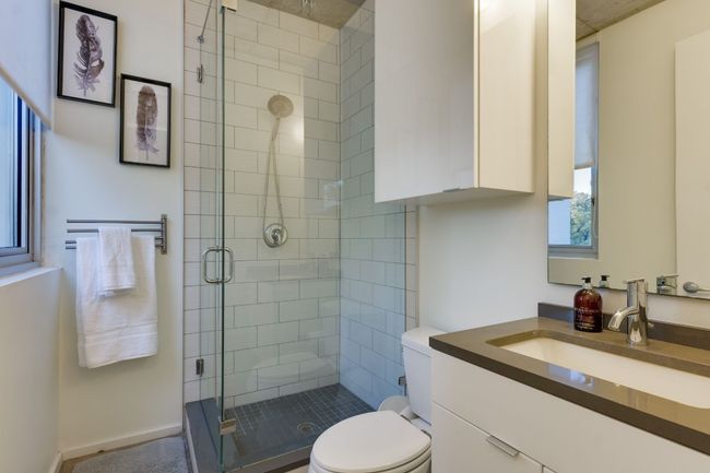 Bathroom featuring vanity, toilet, and a shower with shower door | Image 31