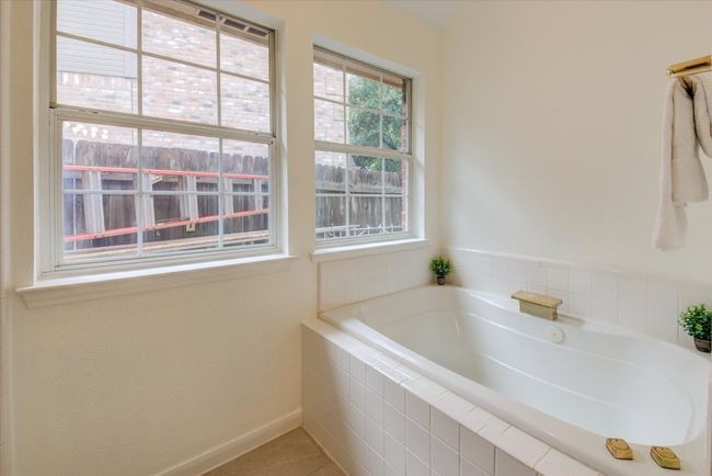 Shower located across from the tub | Image 18