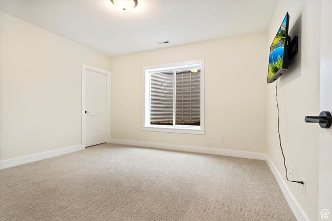 Carpeted spare room with baseboards and visible vents | Image 32
