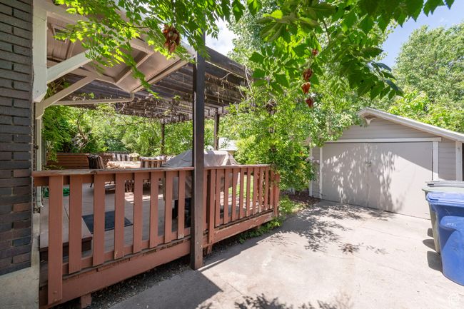 Wooden deck featuring an outbuilding, driveway, and a pergola | Image 30