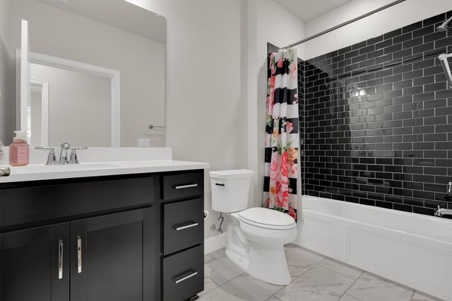 2nd Bathroom featuring marble finish flooring, vanity, toilet, shower / tub combo with curtain, and baseboards | Image 15