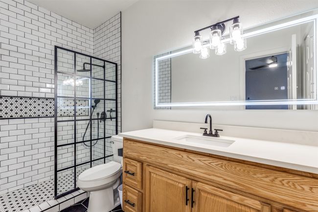 Full bath featuring a shower stall and vanity | Image 11