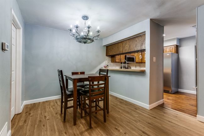 Dining room featuring a fandelier and wood finished floors | Image 12