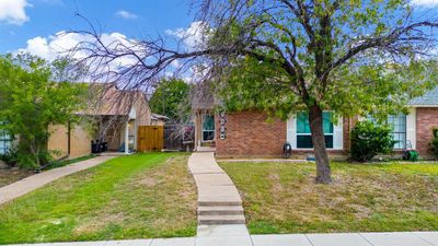 View of front facade with a front lawn | Image 1