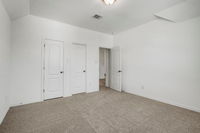 First bedroom featuring upgraded carpet flooring and vaulted ceiling - closet | Image 28