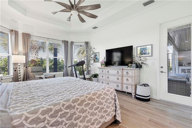 Bedroom with multiple windows, and wood tiled floor | Image 46