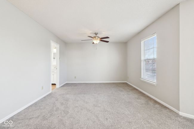 carpeted spare room featuring a ceiling fan and baseboards | Image 38
