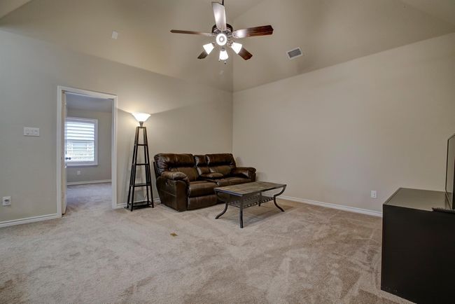 Living area featuring carpet floors, a ceiling fan, and vaulted ceiling | Image 27