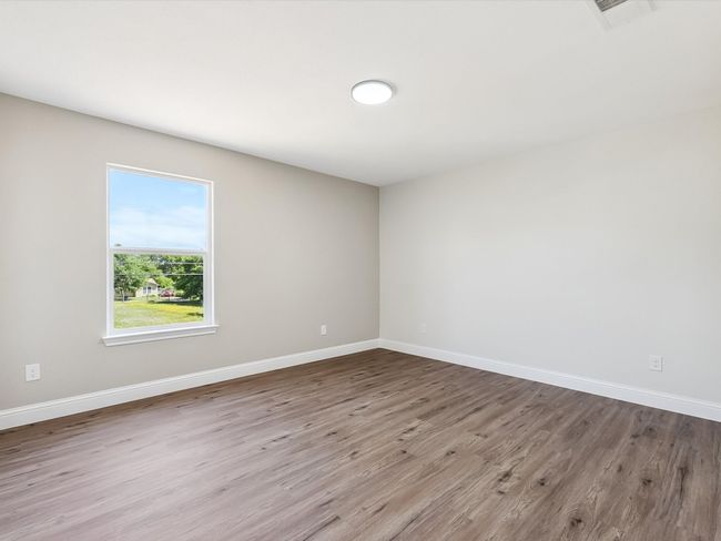 Spare room featuring wood finished floors, visible vents, and baseboards | Image 20