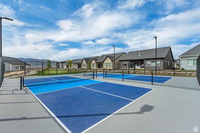 View of sport court featuring fence and a residential view | Image 40