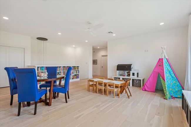 Dining area featuring a ceiling fan, light wood finished floors, and recessed lighting | Image 21