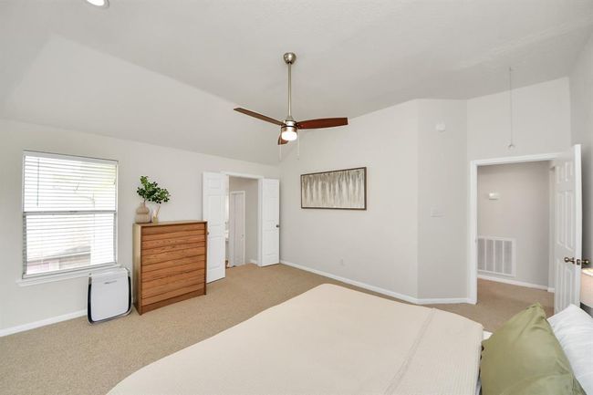 Another look at the primary bedroom highlights its spacious design and serene atmosphere. | Image 28