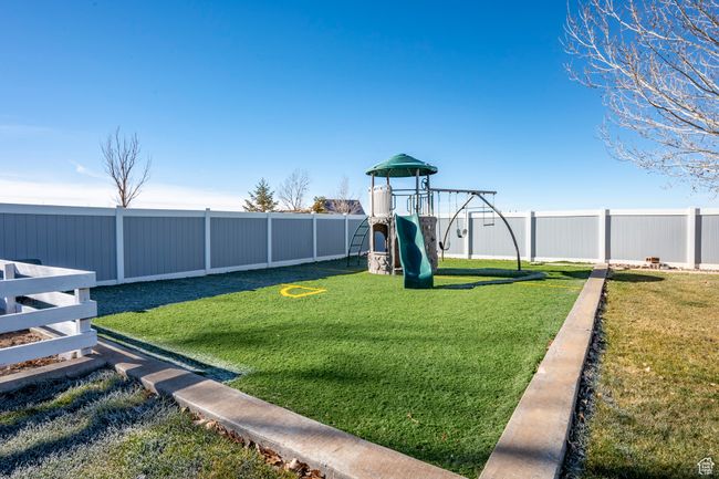View of yard featuring a fenced backyard and a playground | Image 56