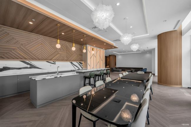 Recreation room featuring a chandelier, a raised ceiling, and recessed lighting | Image 29