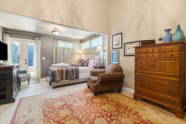 Bedroom featuring light tile patterned floors, french doors, access to outside, and baseboards | Image 23