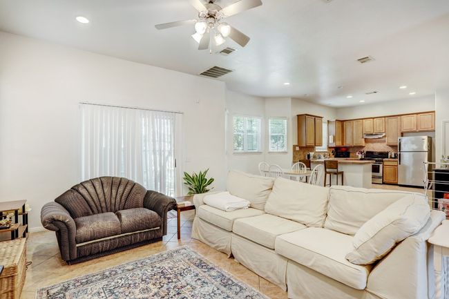Living room featuring ceiling fan, recessed lighting, and light tile patterned floors | Image 4